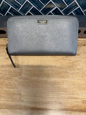 kate spade metallic gray zip-around wallet with gold logo